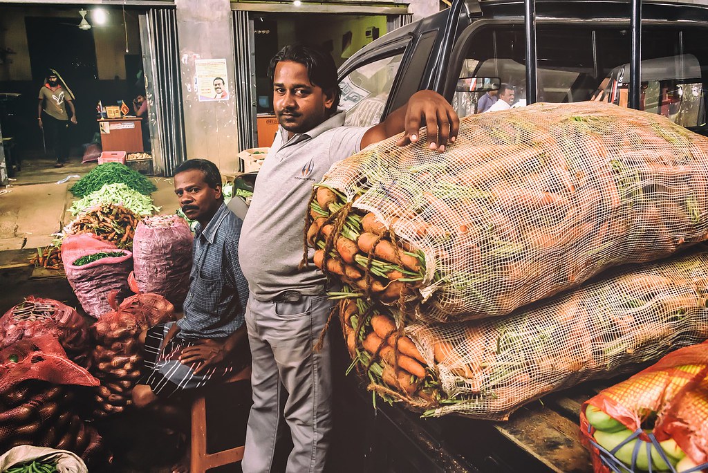 Vendors with produce sacks at Dambulla Market