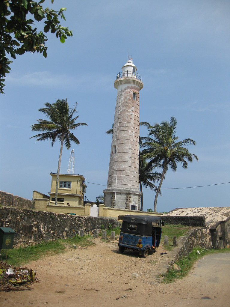 Galle Fort lighthouse with a tuk-tuk at its base