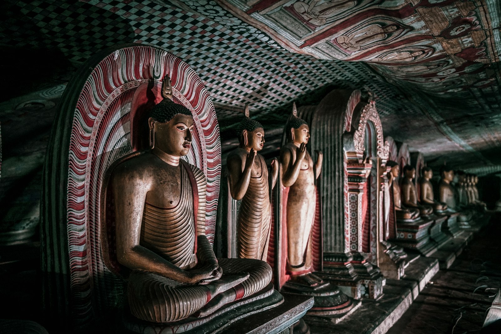 Seated figure among the painted cave statues