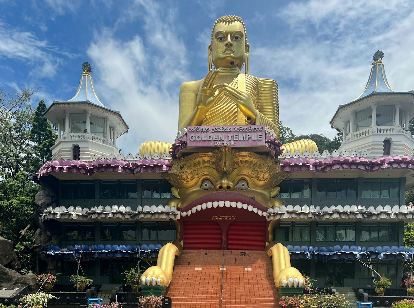 Golden statue against the temple exterior