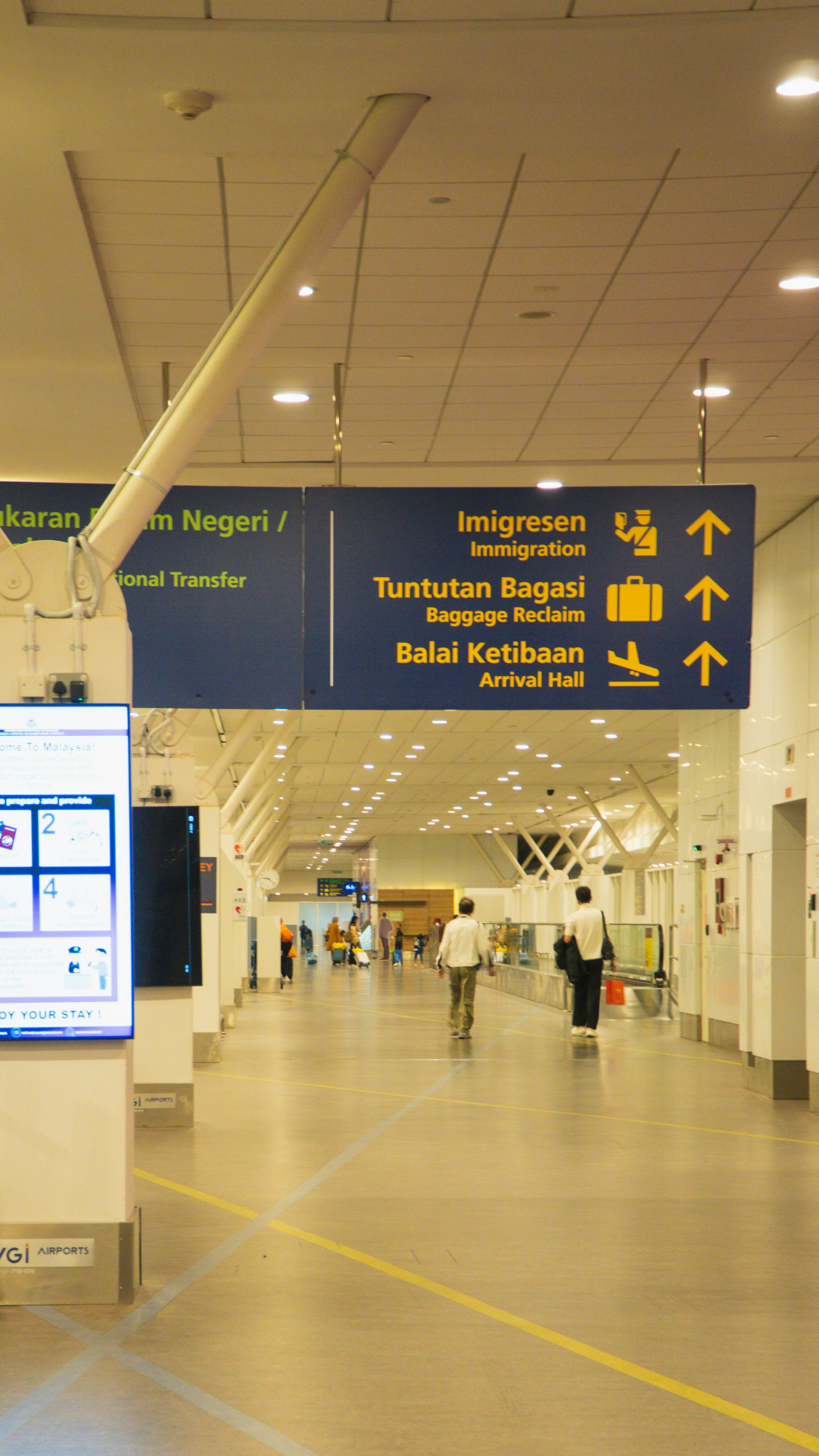 Bright hallway with immigration and baggage reclaim signs