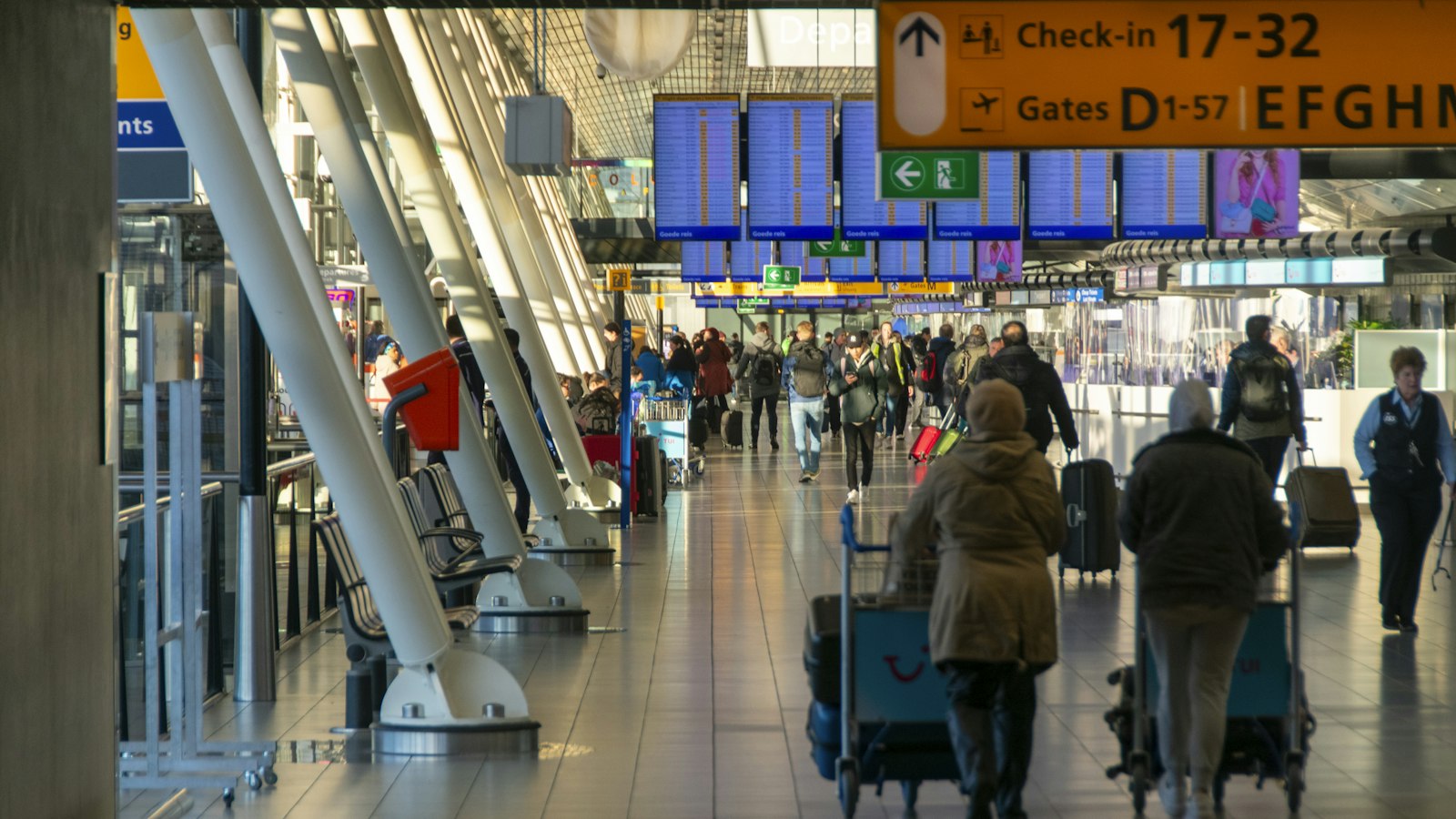 Travellers walking through a bright arrivals hall