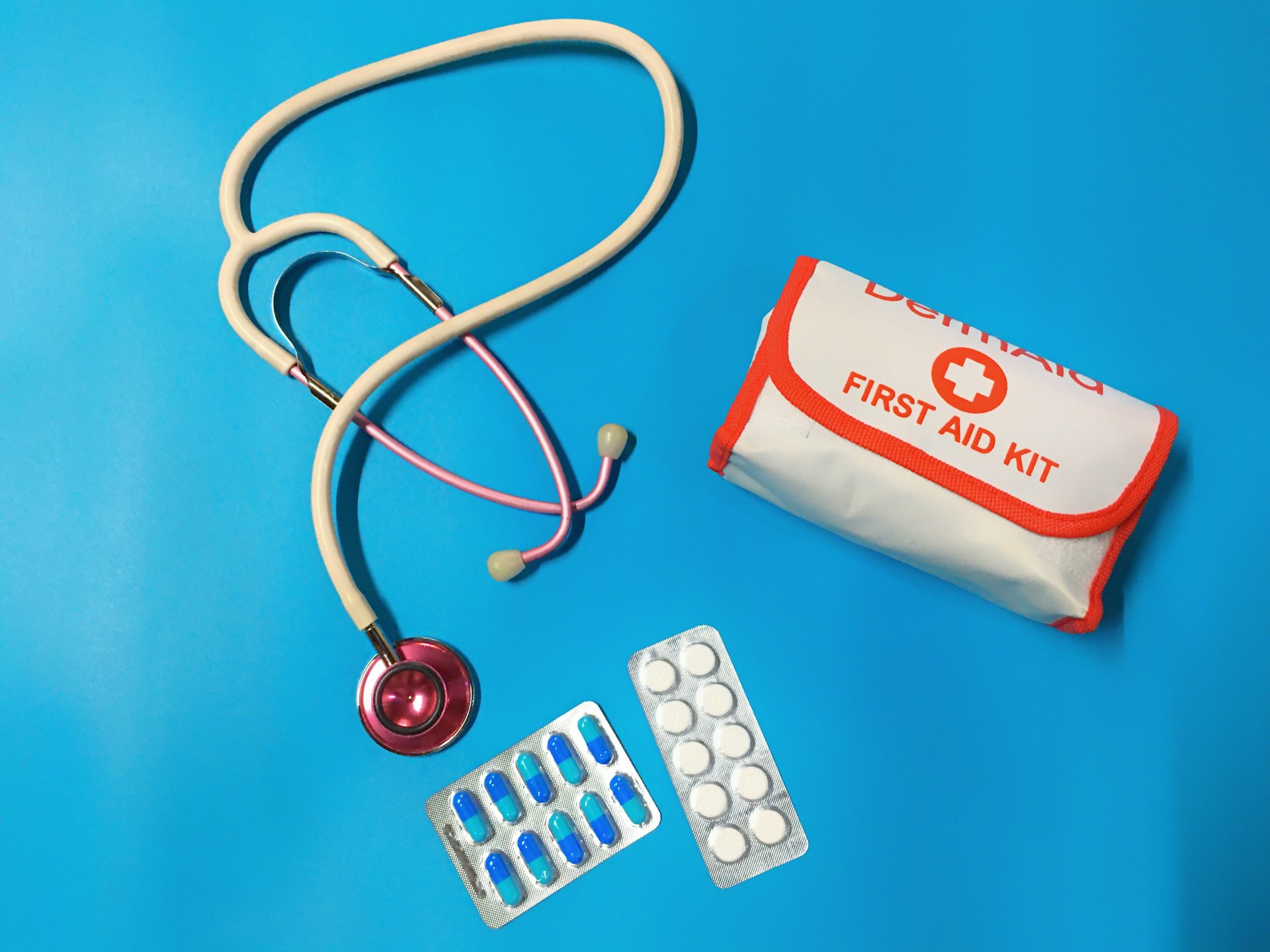 Bag of pills, stethoscope and first-aid kit