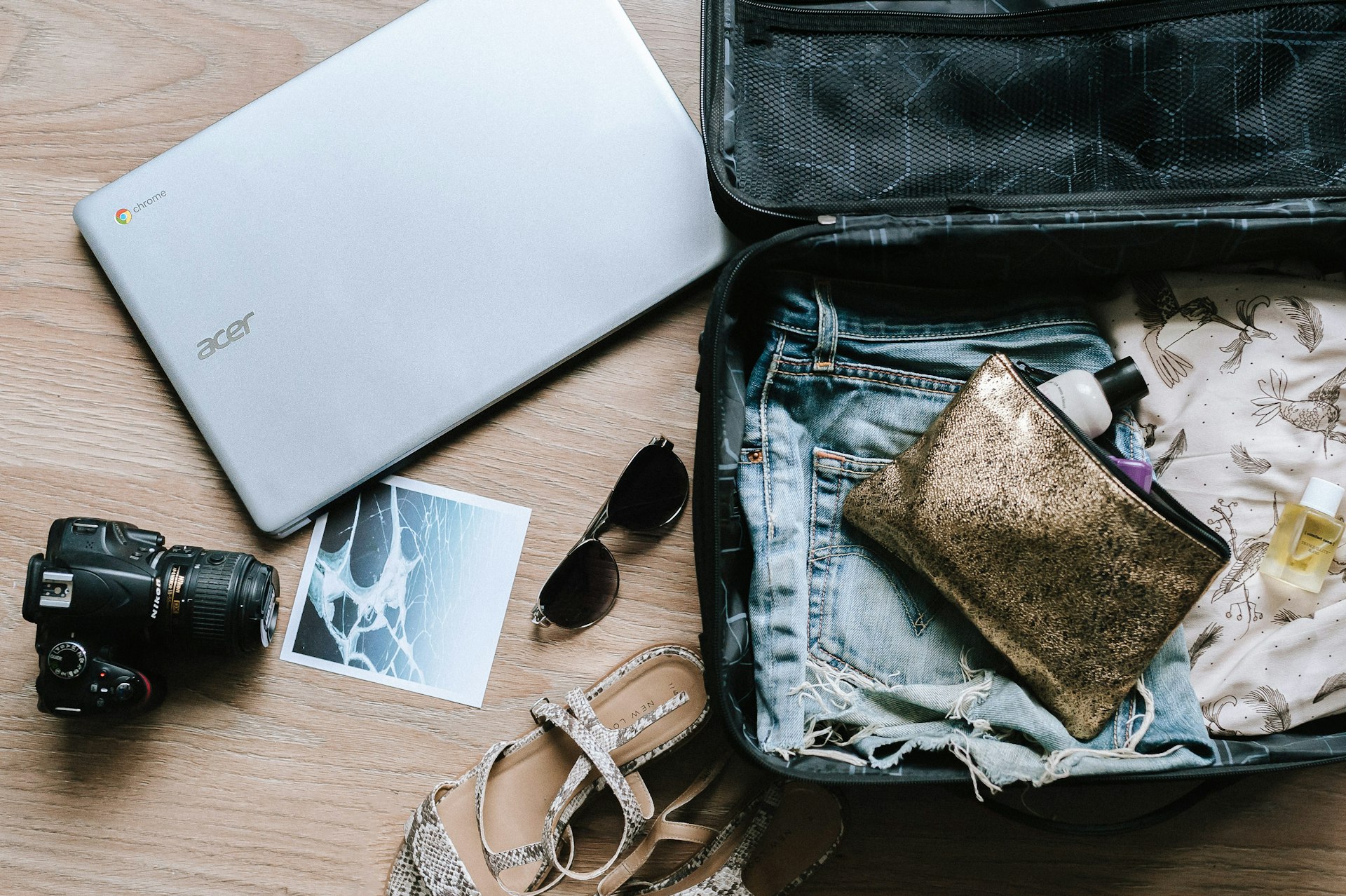 Camera, sunglasses and bag laid out
